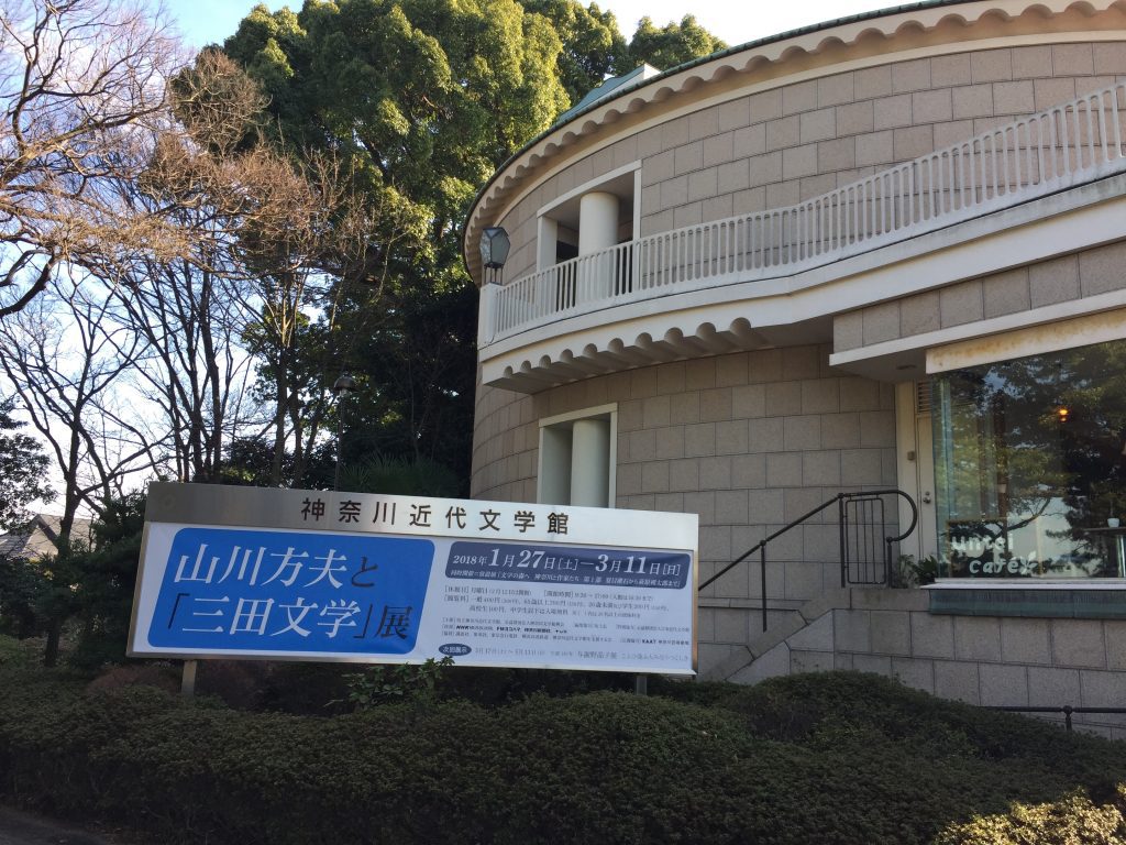 神奈川近代文学館の外部。当時の展示会を宣伝する看板があり、「山川方夫と「三田文学」展」と書かれている。